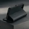 A black leather iPhone case is shown in a studio setting. Anteprima dell’immagine prodotto
