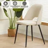 A beige dining chair with black legs is shown in a room with a plant and a window with blinds. Náhled obrázku produktu