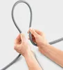 Hands holding a grey flexible hose. Produktbild-Vorschau