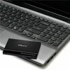 A black PNY Solid State Drive is placed on the keyboard of a silver laptop. Produktbild-Vorschau