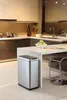 A modern kitchen with a stainless steel trash can in the foreground. Voir les images du produit