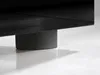 A close-up shot of the base of a black furniture item, showing one of its cylindrical gray supports resting on a white surface. Produktbild-Vorschau