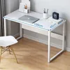 A white computer desk with a laptop, books, and a clock on it, placed in a room with a white chair and wooden floor. Podgląd zdjęcia produktu