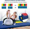 A mother and daughter are using a large exercise ball on a blue gym mat in a bright room with large windows. Produktbild-Vorschau