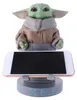 A figurine of Grogu from Star Wars holding a smartphone on a stand. Anteprima dell’immagine prodotto