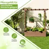 A wooden raised garden bed with a trellis structure, adorned with artificial plants and flowers, set on a green lawn against a light-colored wall. Produktbild-Vorschau