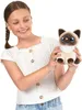 A young girl is holding a stuffed cat toy. Podgląd zdjęcia produktu