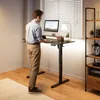 A man is standing at a height-adjustable desk in a home office setting. Anteprima dell’immagine prodotto