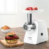 A Bosch meat grinder is shown on a wooden table, with a prepared hamburger and a bowl of salad in the foreground. Anteprima dell’immagine prodotto