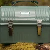 A green Stanley lunch box sits on mossy ground. Podgląd zdjęcia produktu
