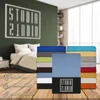 A bedroom scene with a bed and a stack of colorful bedsheets, along with icons and text describing product features. Produktbild-Vorschau