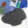A pile of dark aquarium substrate is poured from a bag onto a white surface. Produktbild-Vorschau