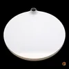 A white, flat, circular vase with a small opening at the top, set against a black background. Voir les images du produit