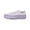 A white Converse sneaker with a platform sole is shown against a white background. Voir les images du produit