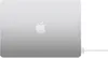 The back of a silver Apple MacBook laptop is shown, with the Apple logo in the center. A white USB-C to MagSafe 3 cable is plugged into the side of the laptop. Produktbild-Vorschau