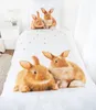 A close-up view of a duvet cover and pillowcase featuring a print of rabbits, set against a white background. Anteprima dell’immagine prodotto