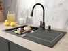 A kitchen sink with a faucet and fruit in a drying rack, with a pitcher of juice in the background. Produktbild-Vorschau