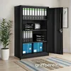 A black metal filing cabinet with its doors open, filled with folders, trays, a small safe, and boxes. A potted plant is to the left, and a rug is on the floor. Náhled obrázku produktu