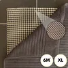 A close-up view of the back of a rug with a grid-like backing and a ribbed texture on the front. Produktbild-Vorschau