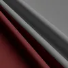 A close-up shot of folded fabric, showing two different colors. Produktbild-Vorschau
