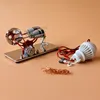 A scientific experiment model with a light bulb and copper wire on a light orange background. Náhľad obrázku produktu