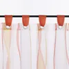 A close-up view of the top section of several transparent curtains hanging from a black rod. Produktbild-Vorschau