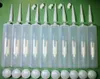 A collection of empty sealant cartridges, nozzles, plungers, and angled tips laid out on a green surface. Produktbild-Vorschau