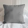 A gray pillow with a white trim is placed on a white bed with white sheets. Náhled obrázku produktu