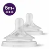 Two clear baby bottle nipples with a purple circle containing text and droplet icons in the upper left corner. Produktbild-Vorschau