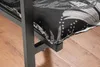 A close-up view of a black metal chair leg and a cushion with a black and white floral pattern. Produktbild-Vorschau