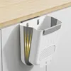 A white and gray foldable trash can is hanging from the edge of a light wood countertop. Produktbild-Vorschau