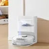 A robot vacuum cleaner and its docking station are shown in a room. Produktbild-Vorschau
