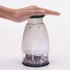 A hand presses down on the top of a manual food chopper filled with chopped red onions. Produktbild-Vorschau