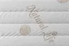 A close-up view of a mattress with embroidered text and patterns. Náhľad obrázku produktu