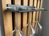 A wine rack mounted on a wooden panel, holding several wine glasses. Produktbild-Vorschau