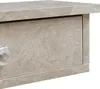 A close-up view of a drawer front with a silver knob on a shelf. Voir les images du produit