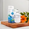 A water filter and its packaging are displayed on a wooden cutting board, with flowers and greenery in the background. Náhľad obrázku produktu