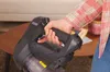 A person is holding a cordless vacuum cleaner. Voir les images du produit