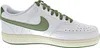 A side view of a white Nike Court Vision Low sneaker with green accents. Produktbild-Vorschau
