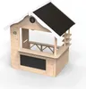 A wooden playhouse designed to look like a shop or stall, with a counter, shelves, and a chalkboard. Produktbild-Vorschau