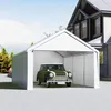 A white carport tent with a vintage green car parked inside, next to a house. Náhled obrázku produktu