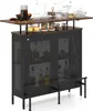 A bar cart with bottles and glasses on top, and storage cabinets below. Podgląd zdjęcia produktu