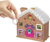 A hand is holding a small, decorative gingerbread house. Podgląd zdjęcia produktu