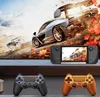 A gaming setup featuring a handheld console, two controllers, and a large screen displaying a racing game. Produktbild-Vorschau