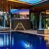A modern outdoor living space with a swimming pool, lounge chairs, and a TV stand with a television. Produktbild-Vorschau