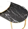 Close-up of a modern coffee table with a marble-look top and gold legs. Produktbild-Vorschau