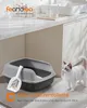 A cat litter box with a scoop is shown next to a cat in a modern bathroom setting. Produktbild-Vorschau