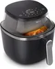A close-up shot of a Philips air fryer with food inside. Produktbild-Vorschau