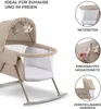 A beige baby bassinet with a canopy and hanging toys, shown from the side. The image also includes inset circles highlighting features like mesh sides, a built-in mosquito net, and an adjustable canopy. Produktbild-Vorschau