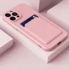 A pink iPhone case with a card slot is displayed on a white and pink surface. Produktbild-Vorschau
